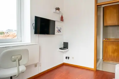 a white couch with two pink pillows on it at Lovely Cedofeita Apartment by Unique Hosts in Porto