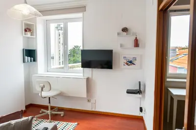 a bedroom with a large bed with blue and white pillows at Lovely Cedofeita Apartment by Unique Hosts in Porto