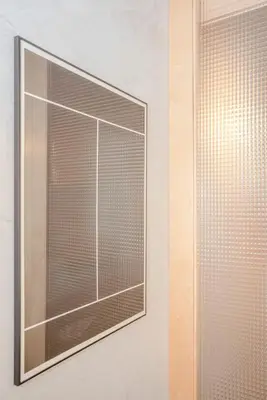 a window with blinds on a white wall at Liiiving in Porto - Bolhão Trendy Apartments in Porto