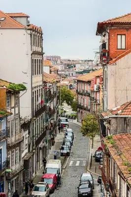a city street with parked cars and buildings at HM – Historic Downtown Batalha Studio in Porto