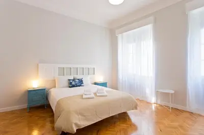 a bedroom with a large bed with two towels on it at ORM Catedral & São Bento & Luiz Apartments in Porto