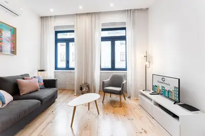 a living room with a couch and a tv at HiddenGem - Cherry on Top in Porto