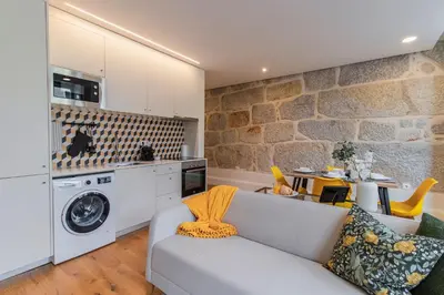 a living room with a couch and a washer at Rodrigues de Freitas 391 by LovelyStay in Porto