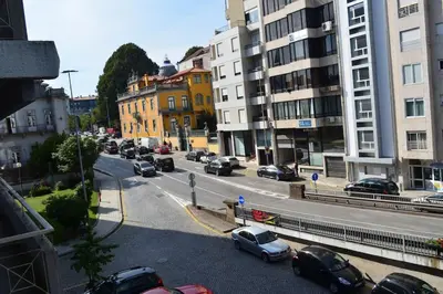 a city street with cars parked on the road at Sense Porto in Porto