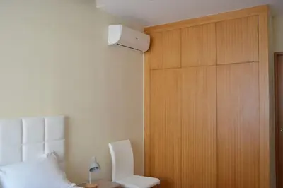 a bedroom with a bed and a wooden door at Sense Porto in Porto