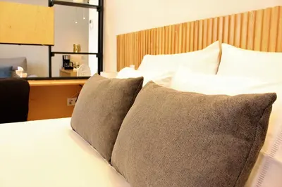 a bedroom with a bed with two pillows on it at Oporto Prime Studios in Porto