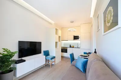 a living room with a couch and a flat screen tv at Lapa City Flat Porto - by Guest SPA in Porto