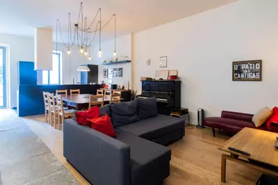 a living room with a couch and a dining room at Music Shell by LovelyStay in Porto