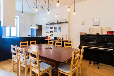 a dining room with a table and a piano at Music Shell by LovelyStay in Porto