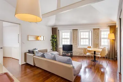a living room with a couch and a table at Traça Apartments by DA'HOME in Porto