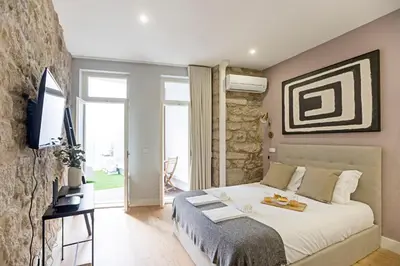 a bedroom with a bed and a television in a room at Cimo de Vila 62 by LovelyStay in Porto