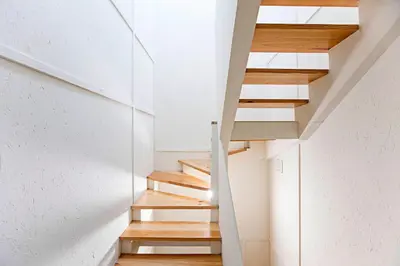a staircase in a house with white walls and wooden floors at Cimo de Vila 62 by LovelyStay in Porto