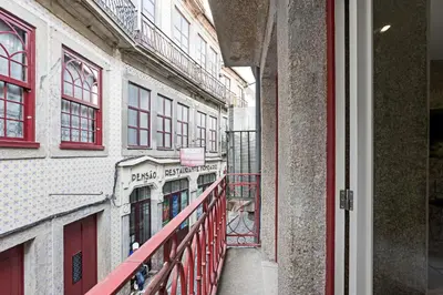 a balcony of a building with a red railing at Cimo de Vila 62 by LovelyStay in Porto