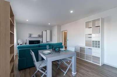 a living room with a green couch and a table at Downtown 1BR Apartment W/ Balcony by LovelyStay in Porto