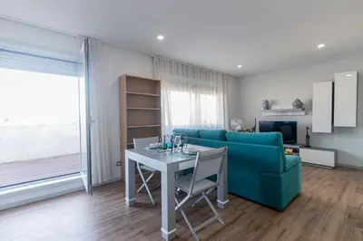 a living room with a blue couch and a table at Downtown 1BR Apartment W/ Balcony by LovelyStay in Porto