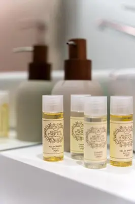 four bottles of honey sitting on a shelf at Dom João Premium Apartment by DA'HOME in Porto
