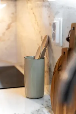 two wooden utensils in a cup on a counter at Dom João Premium Apartment by DA'HOME in Porto