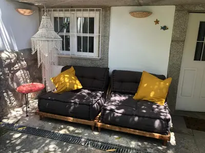 a black couch with yellow pillows on a patio at Casa do Teatro in Porto