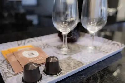 a tray with three wine glasses and a book at Porto Santa Maria Apartments in Porto