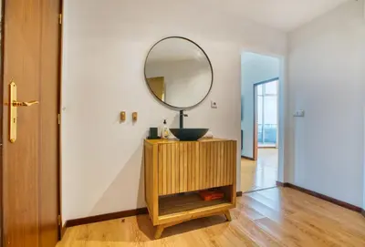 a bathroom with a sink and a mirror on a cabinet at Apartment T1 - Porto in Porto