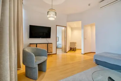 a living room with a chair and a television at Apartment T1 - Porto in Porto