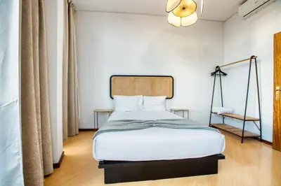 a bedroom with a large bed with white sheets at Apartment T1 - Porto in Porto