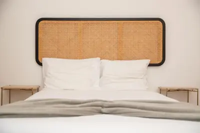 a bed with a headboard and white pillows at Apartment T1 - Porto in Porto