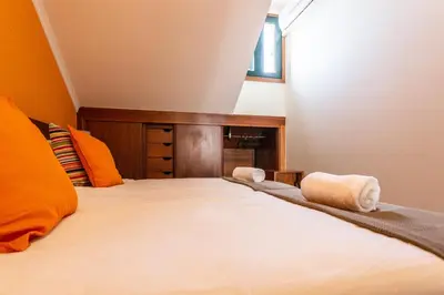 a bedroom with a bed with two towels on it at Porto Residence Campanhã in Porto