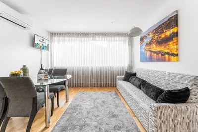 a living room with a couch and a table at GuestReady - Bright home in the heart of Porto in Porto