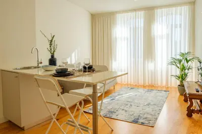 a kitchen with a table and chairs in a room at AgapeStay Porto in Porto