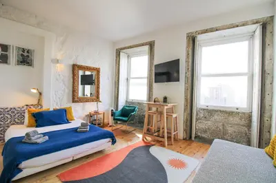 a bedroom with a king sized bed and a desk at Historic Oldtown Getaway in Porto