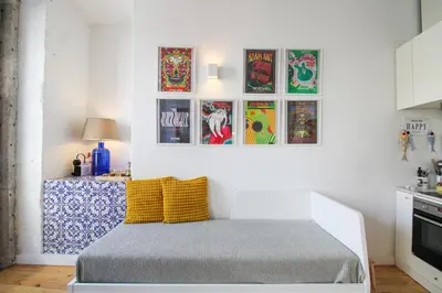 a bedroom with a bed and pictures on the wall at Historic Oldtown Getaway in Porto