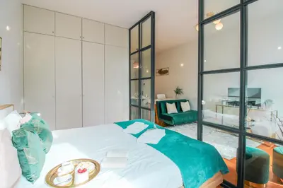 a bedroom with a bed with a tray of food on it at Aliados Sunny Flat in Porto