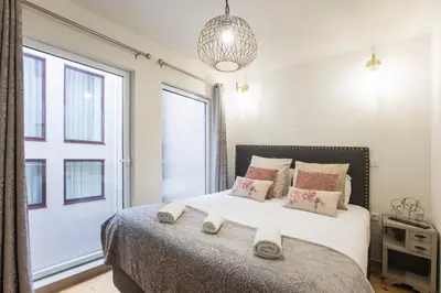 a bedroom with a large bed with towels on it at Alma do Porto - With AC in Porto