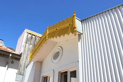 a yellow beam on the side of a building at Amazing Flores Duplex in Porto