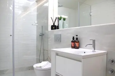 a bathroom with a sink and a shower and a toilet at Amazing Flores Duplex in Porto