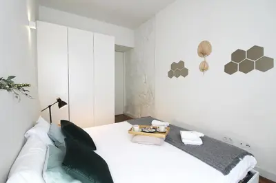 a white room with a white couch and a table at Cativo Design Apartment in Porto