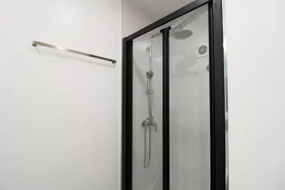 a shower with a glass door in a bathroom at Cativo Design Apartment in Porto