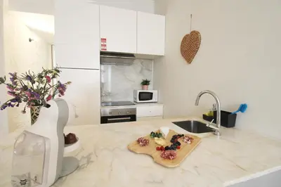 a kitchen with a sink and a cutting board on a counter at Cativo Design Apartment in Porto