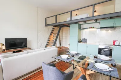 a living room with a couch and a table at Cativo Mezzanine Loft in Porto