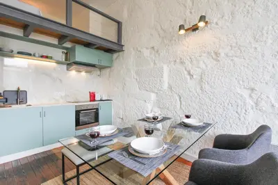 a dining room with a glass table and two chairs at Cativo Mezzanine Loft in Porto