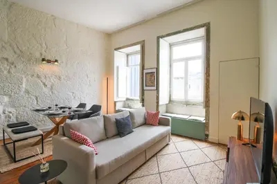 a living room with a couch and a table at Cativo Mezzanine Loft in Porto