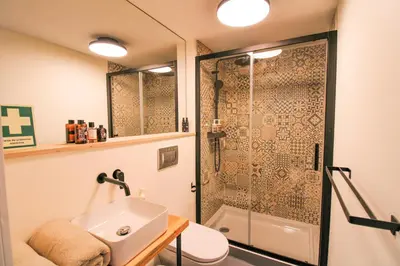 a bathroom with a sink and a shower at Cativo Mezzanine Loft in Porto
