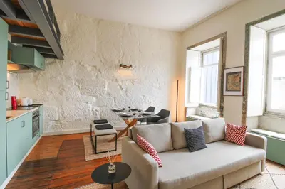 a living room with a couch and a table at Cativo Mezzanine Loft in Porto