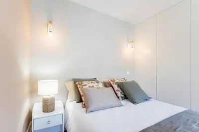 a bedroom with a bed with pillows on it at Cosy Flat Near Douro in Porto
