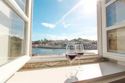 two glasses of wine sitting on a window sill at Douro Dreams in Porto