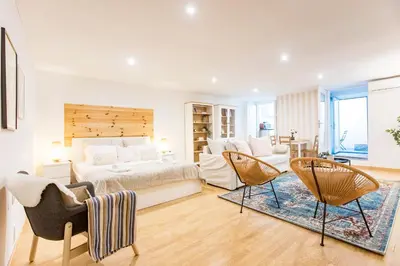 a bedroom with a bed and a couch and chairs at Almada Hideaway w/ AC & Private Pool by LovelyStay in Porto