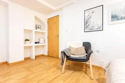 a bedroom with a chair and a bed at Almada Hideaway w/ AC & Private Pool by LovelyStay in Porto