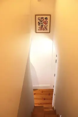 a hallway with a stairway leading to a white wall at Living Aliados Mezzanine Flat W/ AC in Porto