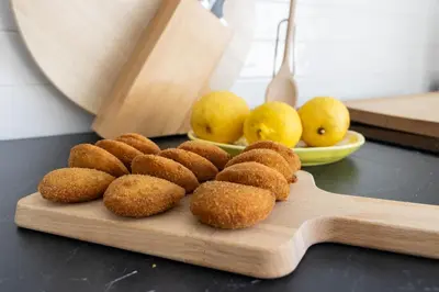 a pile of food on a cutting board with lemons at Fradelos Porto Centro in Porto
